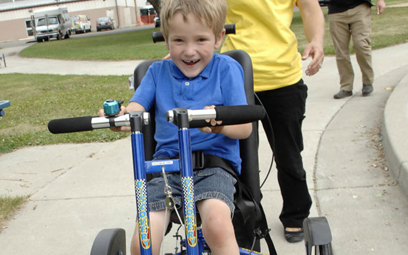 Happy kid who found funding for adaptive bikes