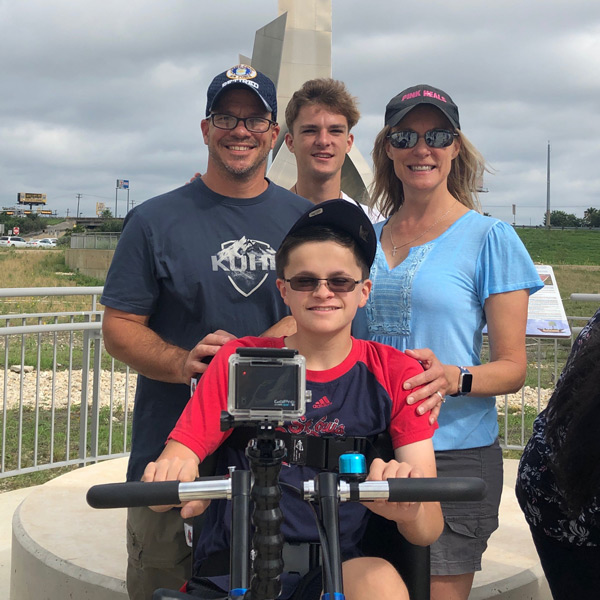 The Pivirotto family poses for a photo after receiving their adaptive bicycle.