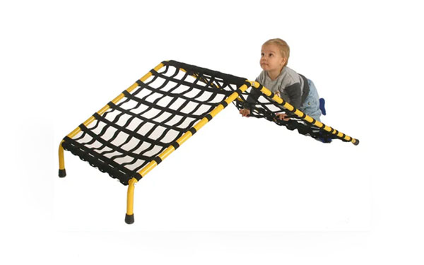 Toddler climbing the early intervention Freedom Climber