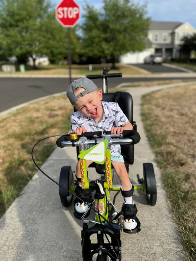 Remi with cerebral palsy riding a bike