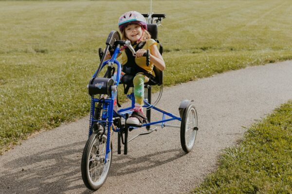 Happy kid riding Freedom Concepts Bike
